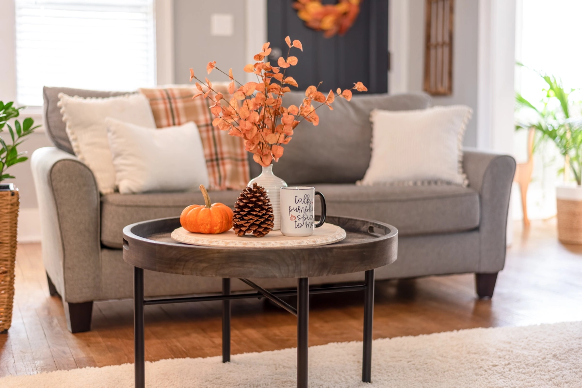 Fall coffee, pumpkins, and pine cones.